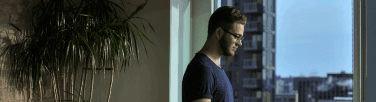 A man sitting in a chair with a laptop.